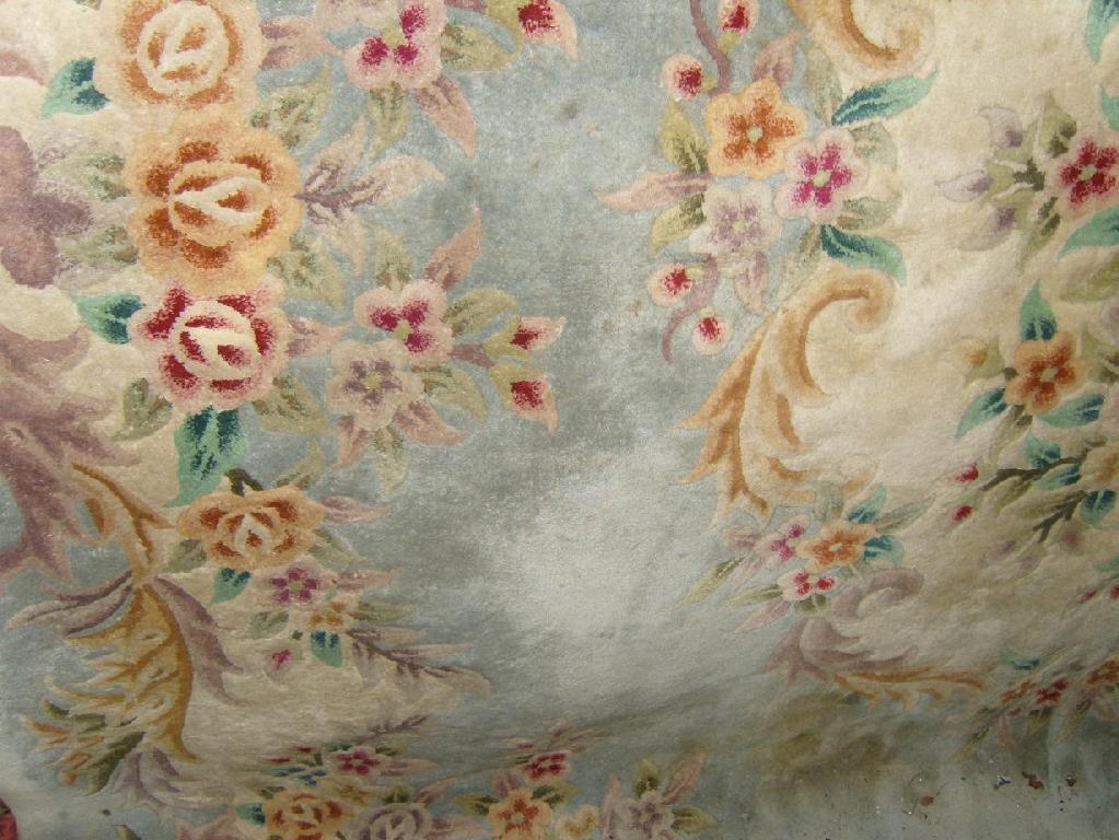 Appraisal: A Chinese wool carpet with pink and gold rose decoration