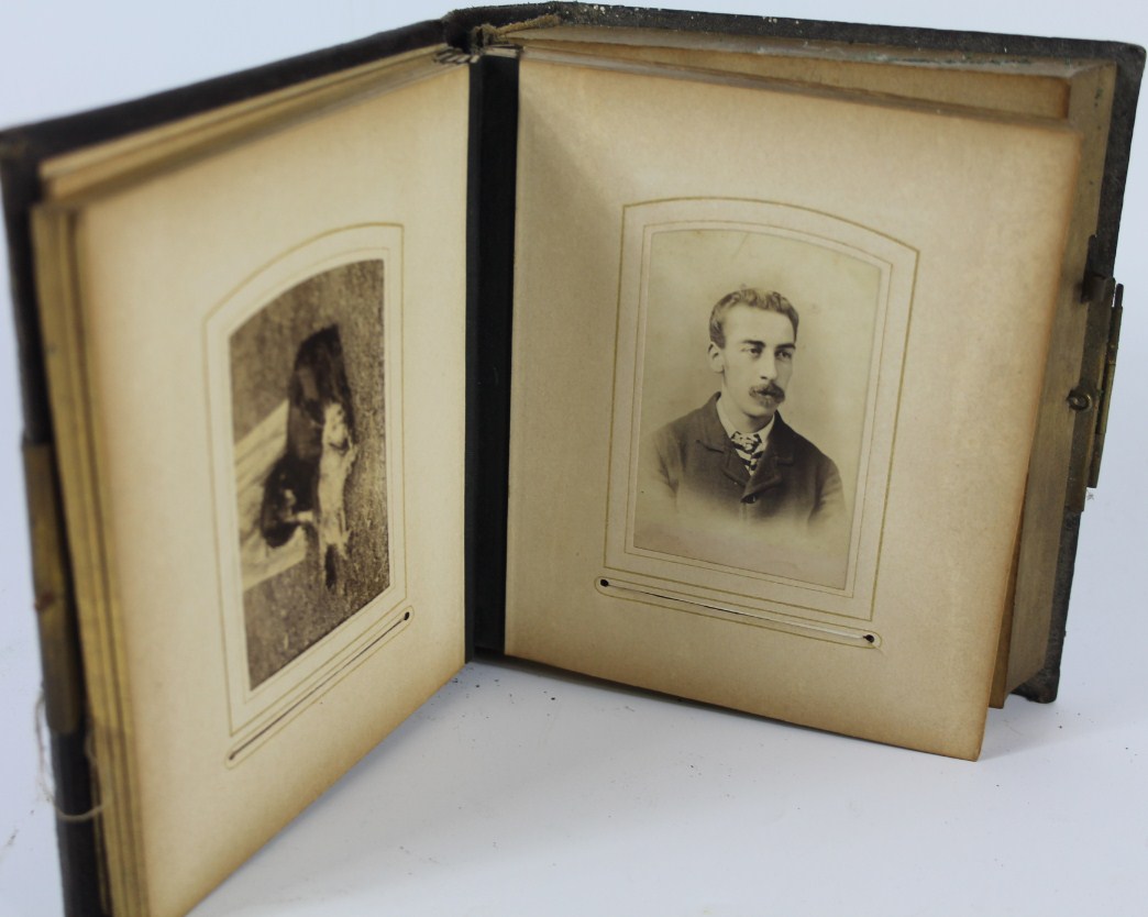 Appraisal: A Victorian embossed leather photograph album with integral Swiss musical