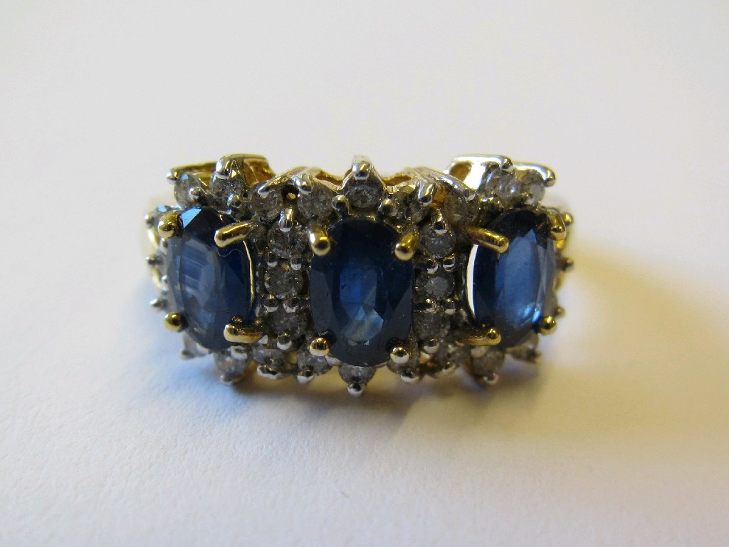 Appraisal: Eighteen carat gold sapphire and diamond triple flower head cluster