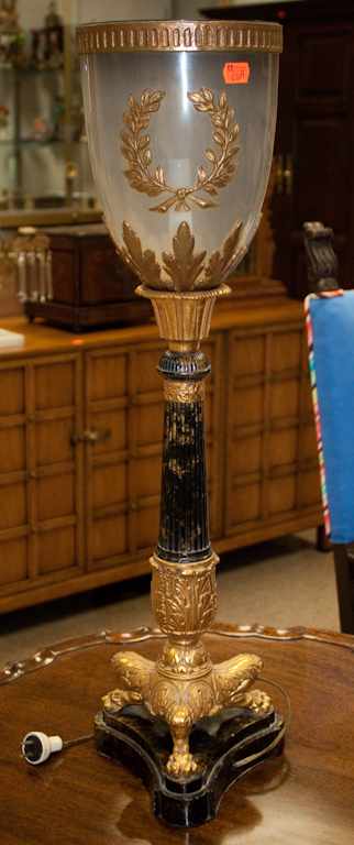 Appraisal: Neoclassical style gilt and patinated metal torchere with smoked glass