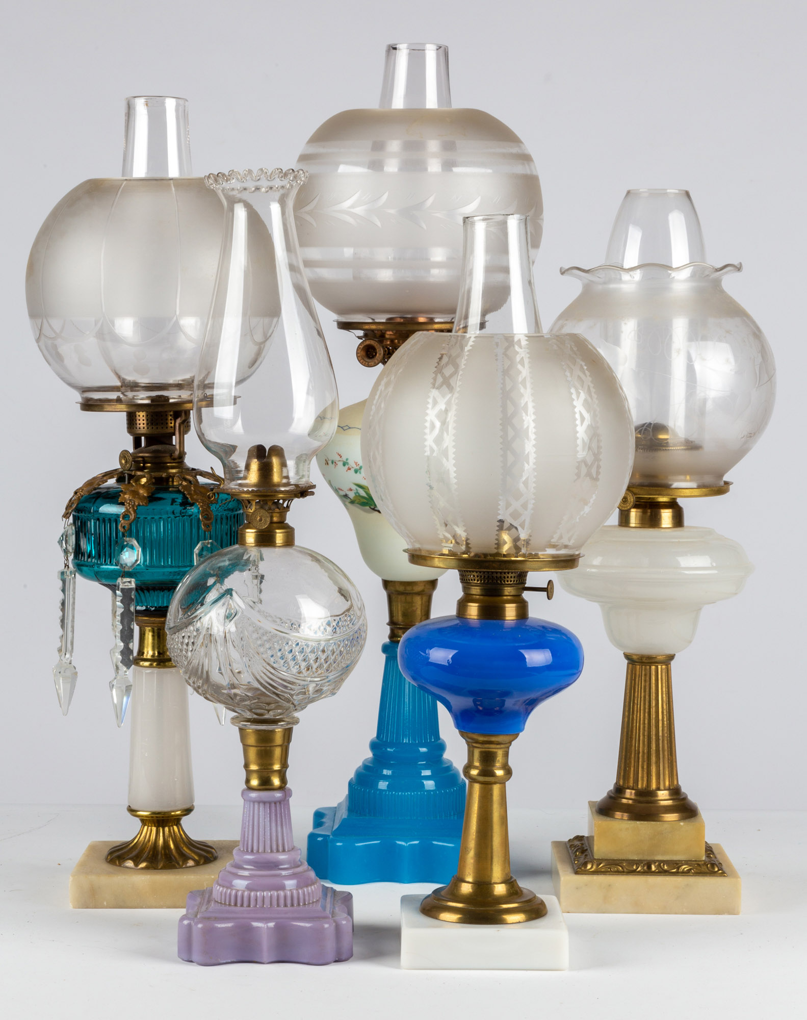 Appraisal: VARIOUS GLASS OIL LAMPS All circa including triple swag and