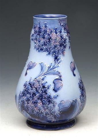 Appraisal: A MOORCROFT 'LILAC' FLORIAN WARE VASE signed W Moorcroft in