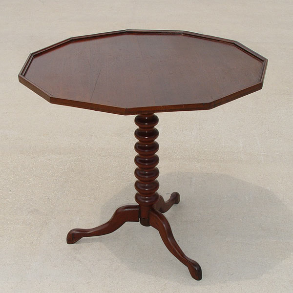 Appraisal: SPOOL TURNED MAHOGANY STAND The sided top tilts and revolves