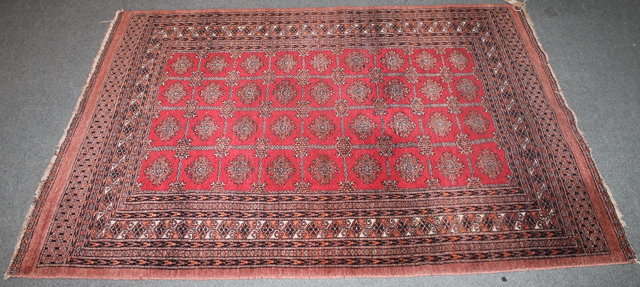 Appraisal: A PAKISTAN BOKHARA TYPE RUG with four rows of medallions