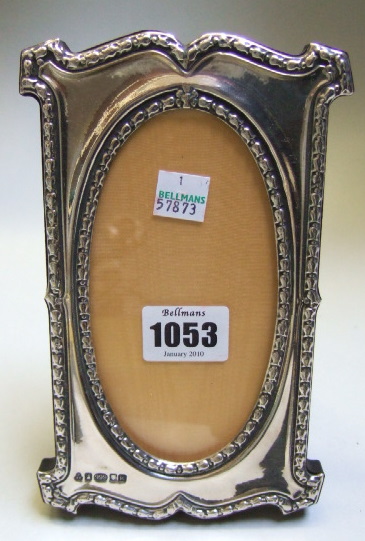 Appraisal: A silver mounted shaped rectangular photograph frame with an oval