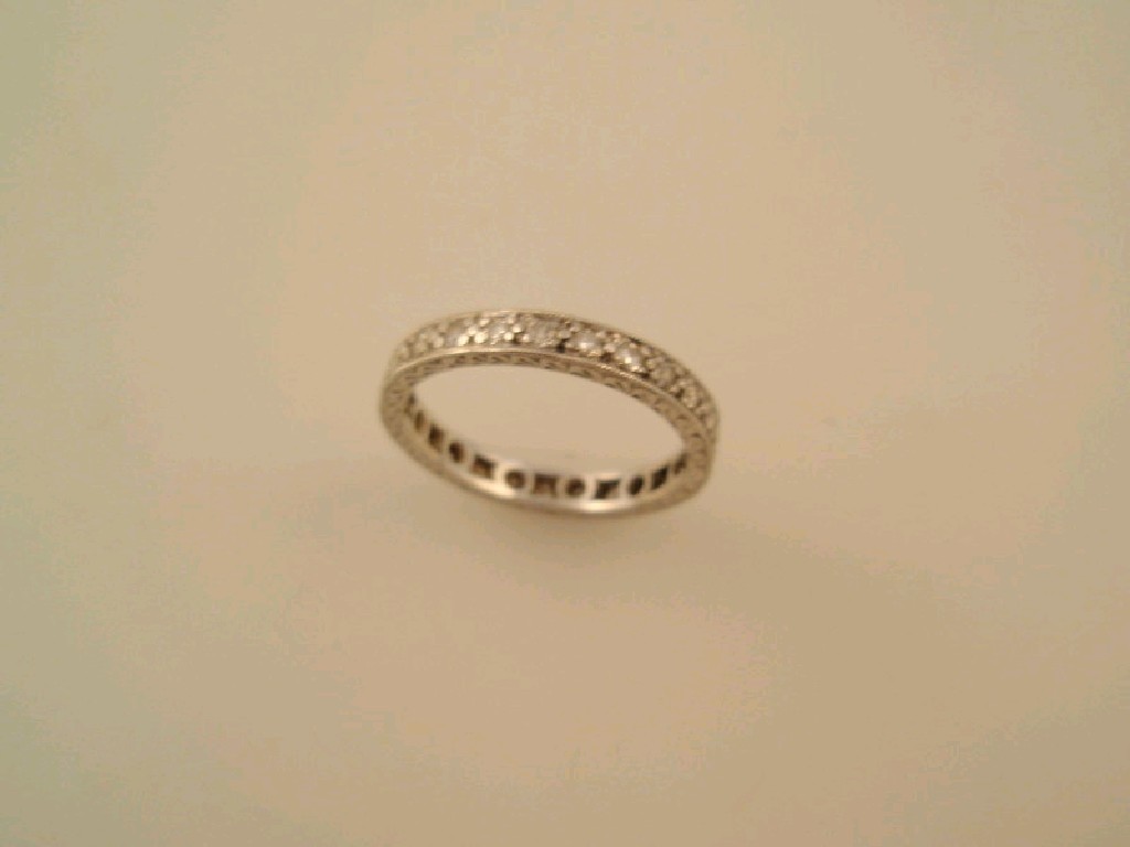 Appraisal: A full hoop eternity ring set with tiny diamonds in