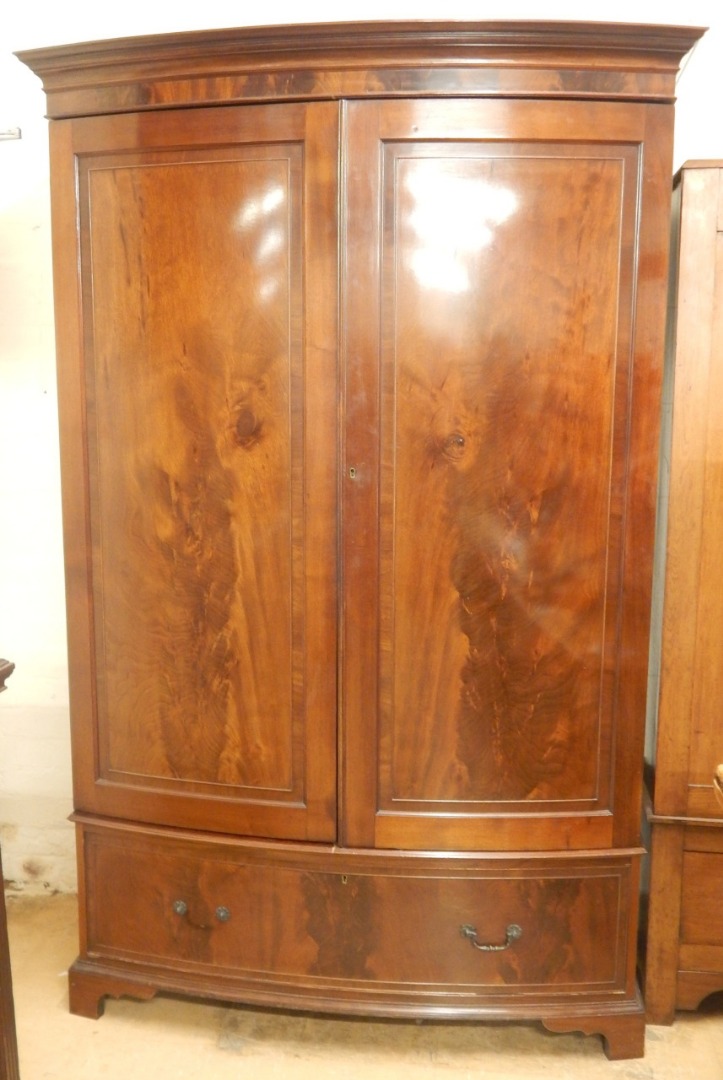 Appraisal: An early thC figured mahogany bow fronted wardrobe with two