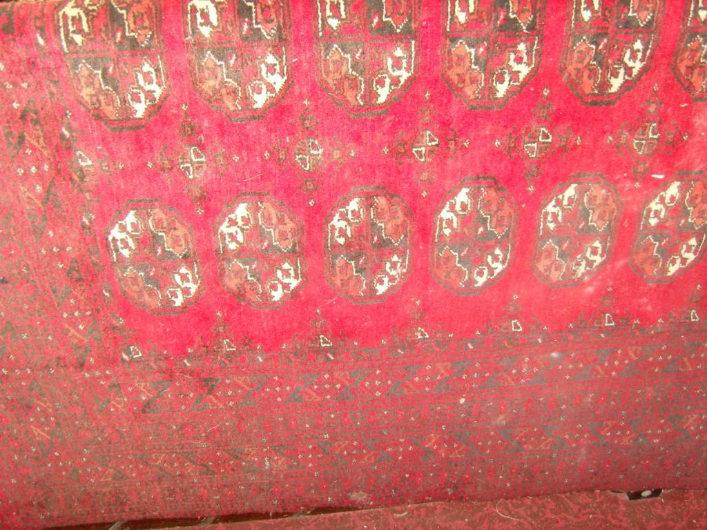 Appraisal: A large red ground eastern wool carpet with repeating gul