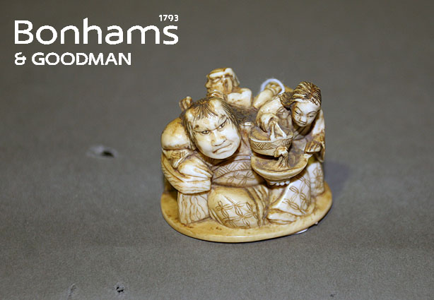 Appraisal: A Japanese netsuke depicting a seated giant attended by a