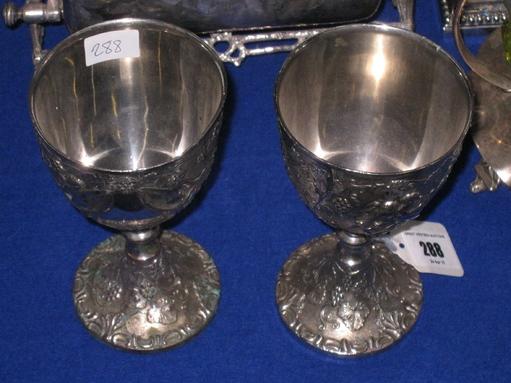 Appraisal: Pair of embossed white metal goblets