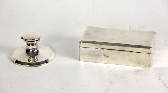 Appraisal: A rectangular silver cigarette box London with engine turned hinged