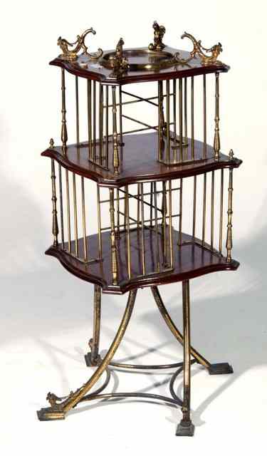 Appraisal: AN EDWARDIAN BRASS AND MAHOGANY FRAMED REVOLVING BOOKSTAND on two