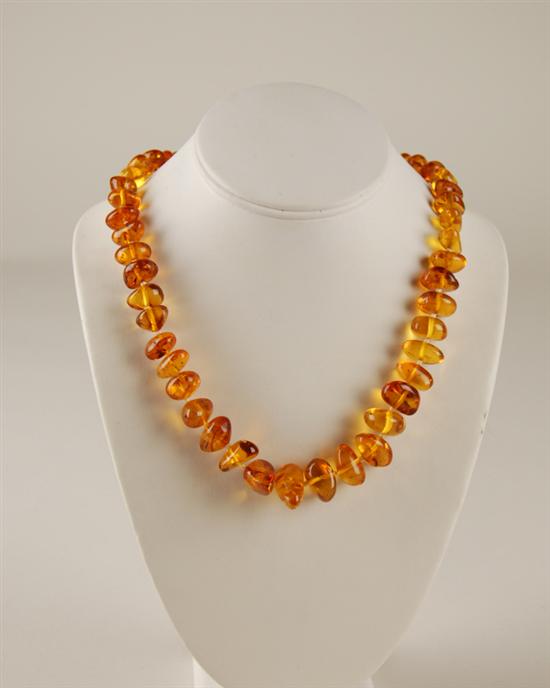 Appraisal: A Graduated Strand of Amber Beads Necklace with a gilt