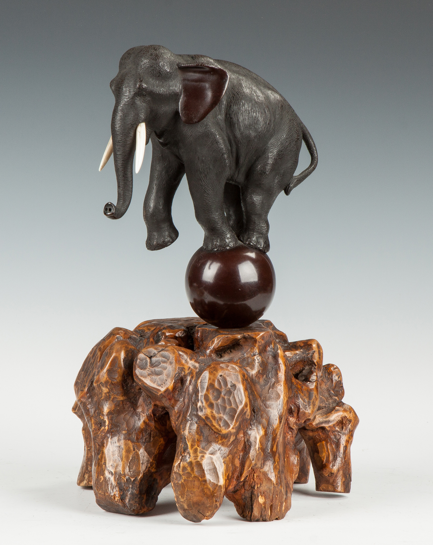 Appraisal: Bronze Elephant on Natural Root Base C Sgn