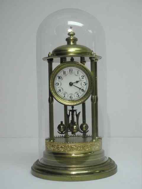 Appraisal: Jahresuhren-Fabrik brass anniversary clock with glass dome case Marked ''JAHRESUHREN-FABRIK