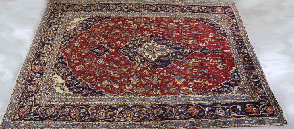 Appraisal: Ishfahan Wool CarpetHaving navy blue central oval medallion overall blue