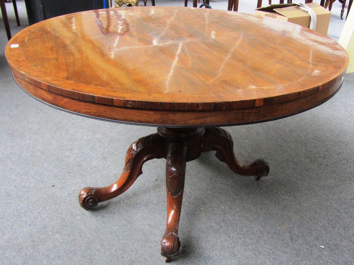 Appraisal: A Victorian yew wood banded rosewood circular snap top breakfast