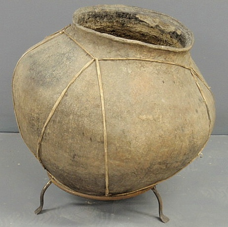 Appraisal: Large Asian earthenware pottery leather-bound pot resting on a metal