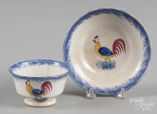 Appraisal: Blue spatter cup and saucer with rooster decoration