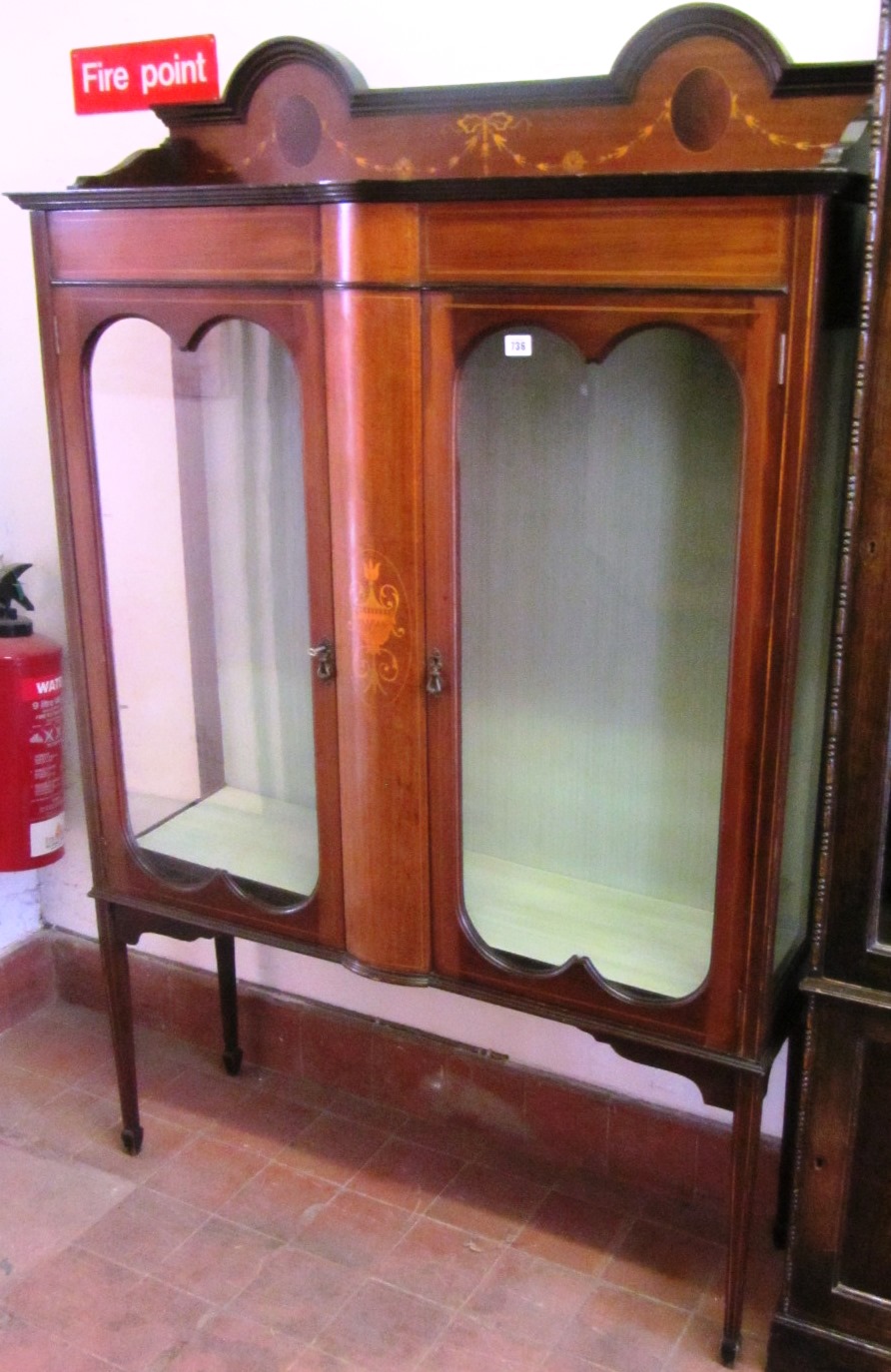 Appraisal: An Edwardian marquetry inlaid mahogany two door display cabinet on