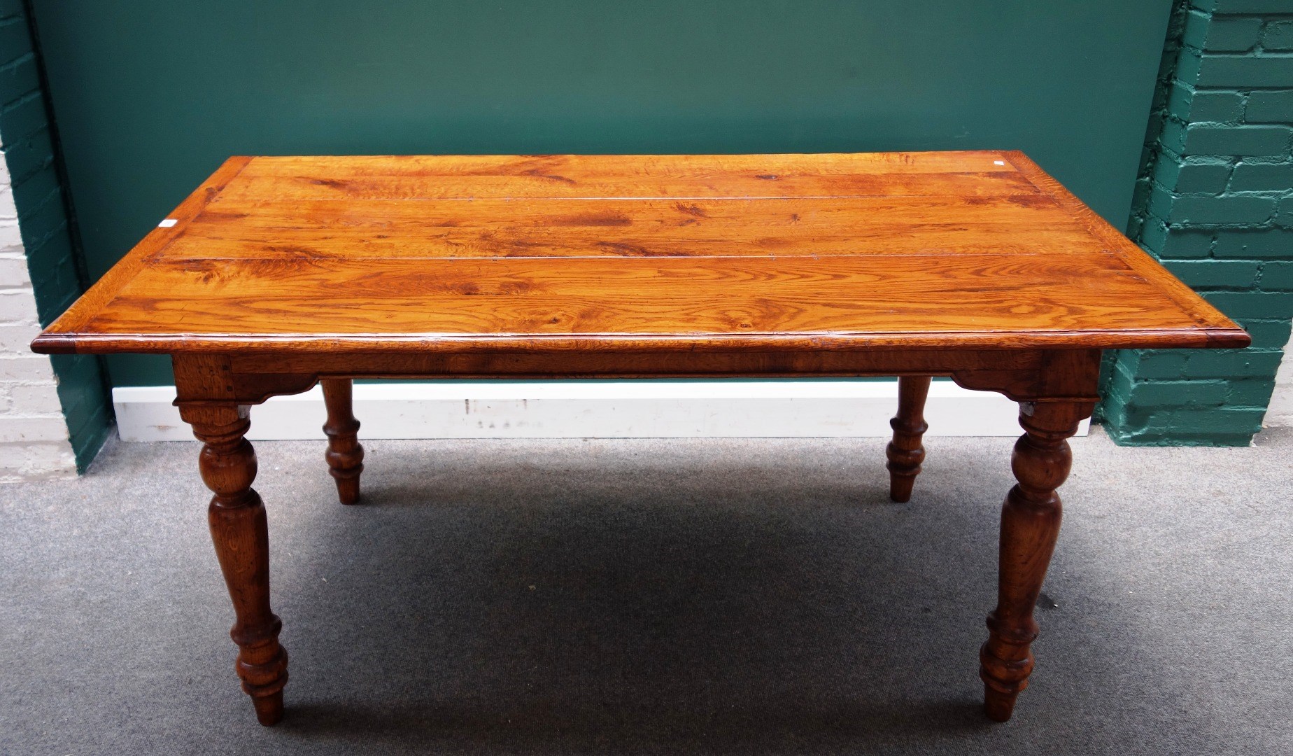 Appraisal: A th century style oak plank top dining table on