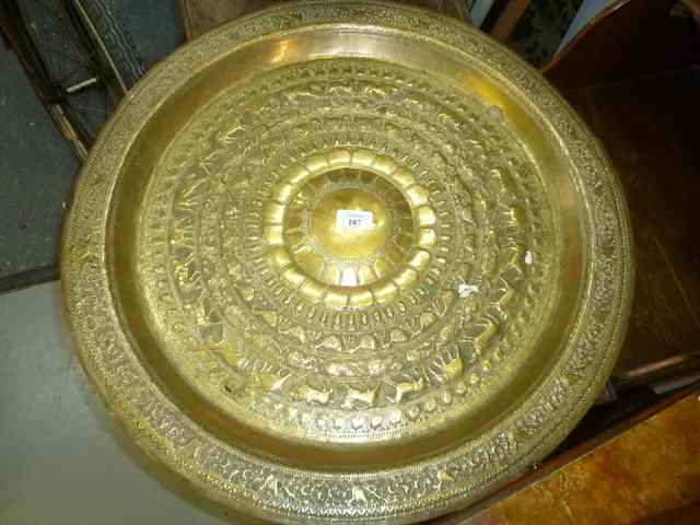 Appraisal: AN INDIAN CIRCULAR BRASS CHASED AND ENGRAVED TRAY diameter together