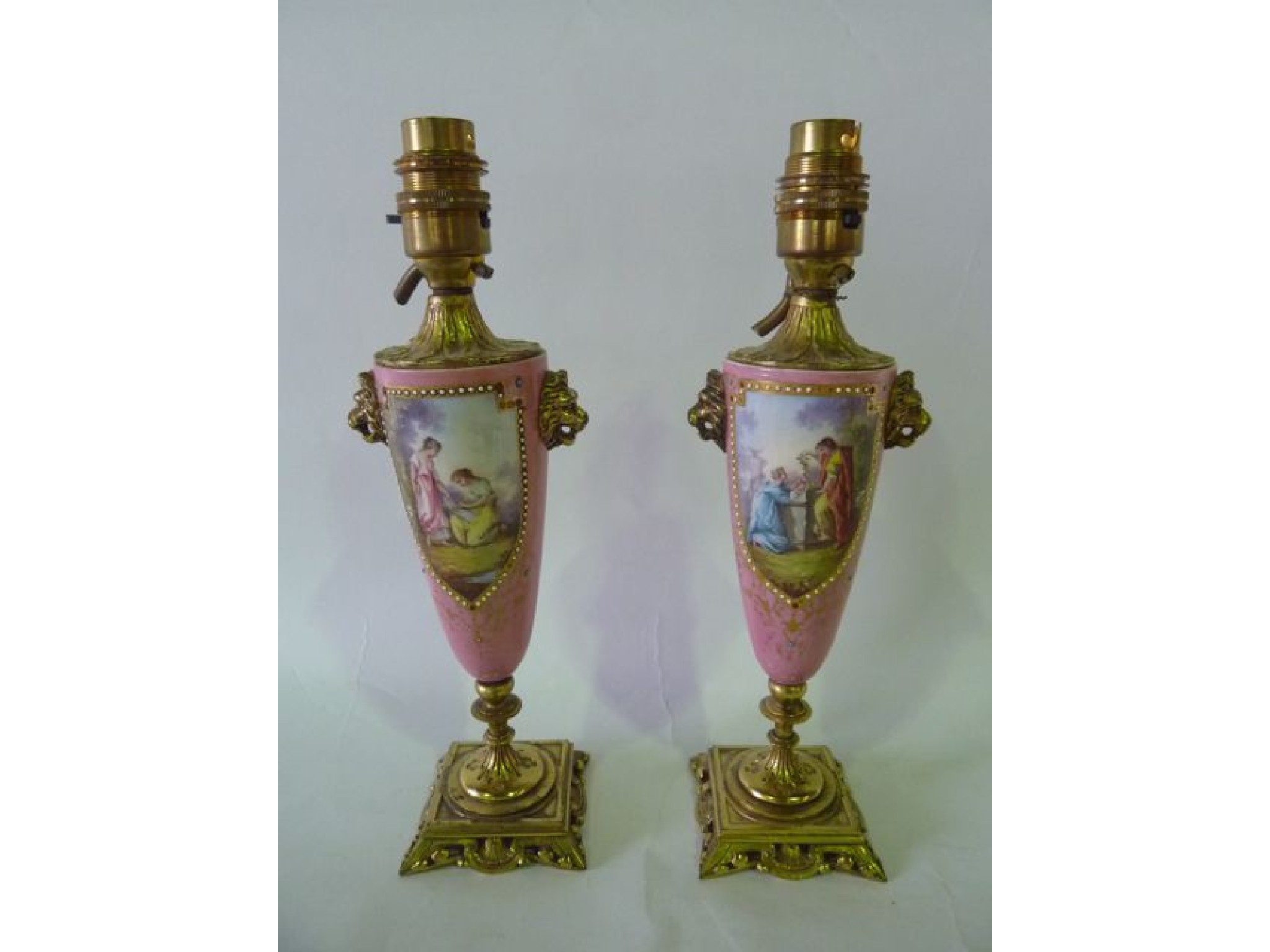 Appraisal: A pair of th century pink ground vases with painted