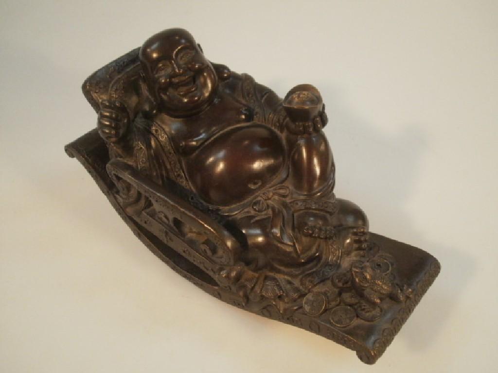 Appraisal: A Chinese cast bronze Buddha on a rocking chair