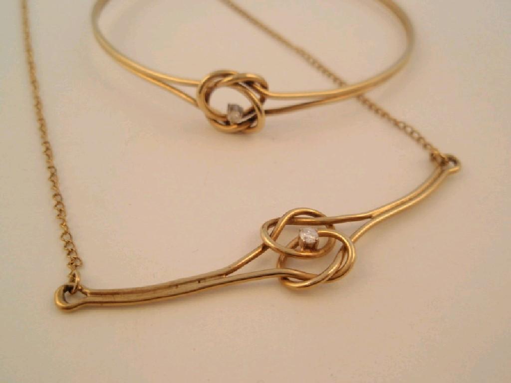 Appraisal: A ct gold lovers knot small diamond set bangle and