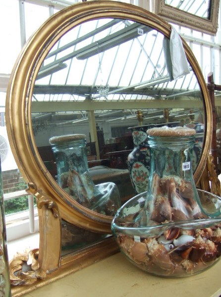 Appraisal: A th century gilt framed overmantel wall mirror the oval