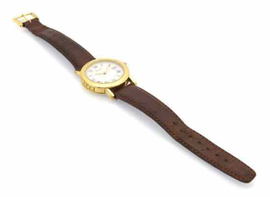 Appraisal: A Gucci Watch with brown leather strap goldtone buckle and