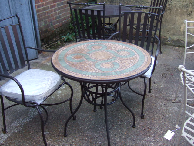 Appraisal: A black painted mosaic top garden table and two matching