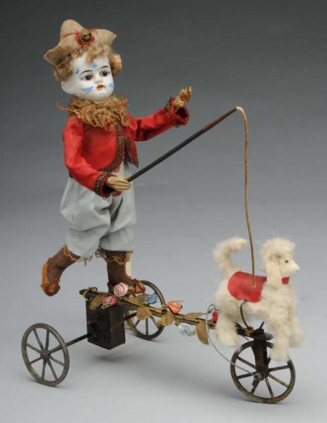 Appraisal: Clown Clockwork Mechanical Toy Description Painted white bisque head clown