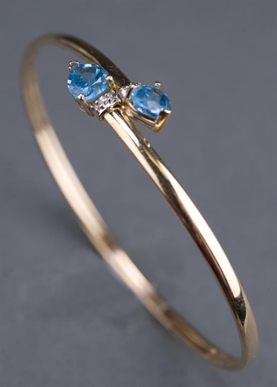 Appraisal: KT yellow gold wrap-around bracelet with blue topaz and diamonds