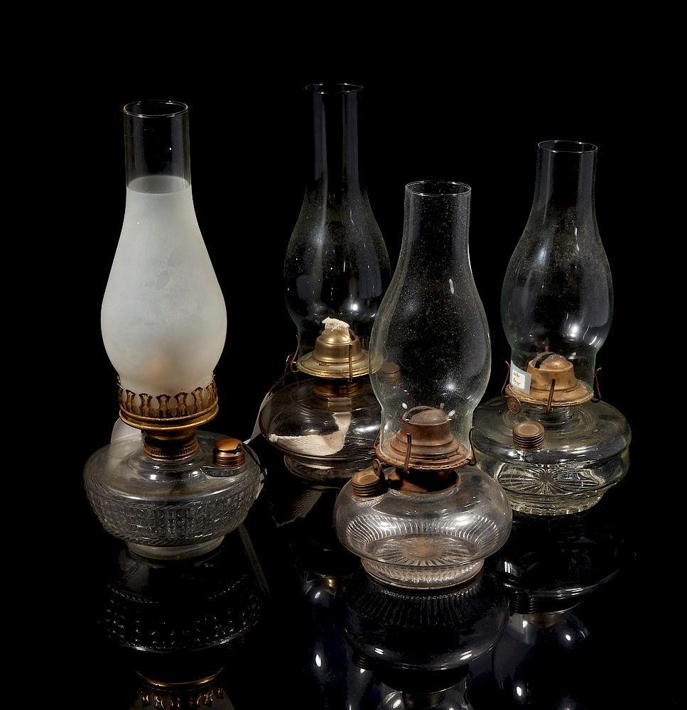 Appraisal: Four Kerosene Lamps Four clear glass kerosene lamps Dimensions largest