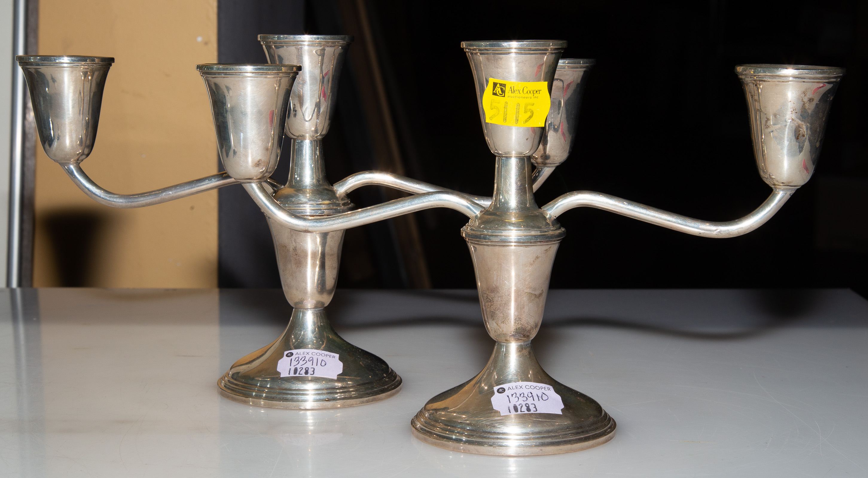 Appraisal: A PAIR OF STERLING WEIGHTED THREE-LIGHT CANDELABRA Converts to single