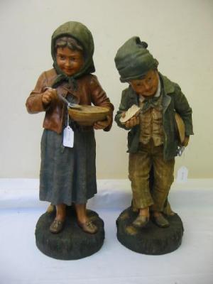 Appraisal: A PAIR OF LARGE AUSTRIAN EARTHENWARE FIGURES modelled as peasant