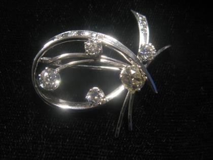 Appraisal: Platinum and diamond brooch s Four petite circular cut diamonds