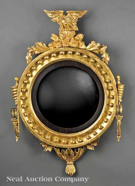 Appraisal: A Regency Giltwood Bullseye Mirror c surmounted by a spread-wing