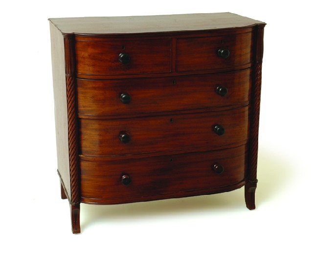 Appraisal: A GEORGE IV MAHOGANY OF DRAWERS The bowed rectangular top