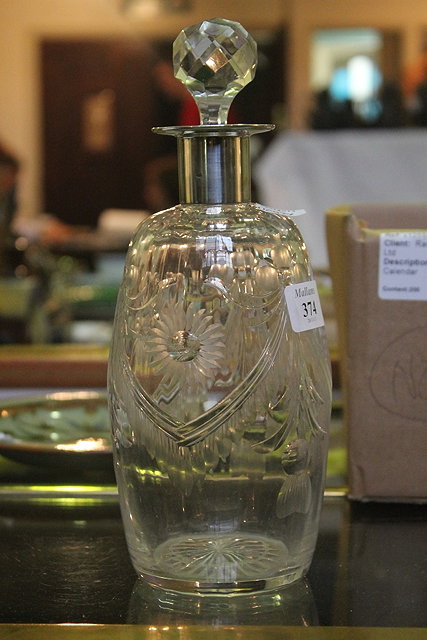 Appraisal: A CUT GLASS DECANTER of baluster form with silver mounted