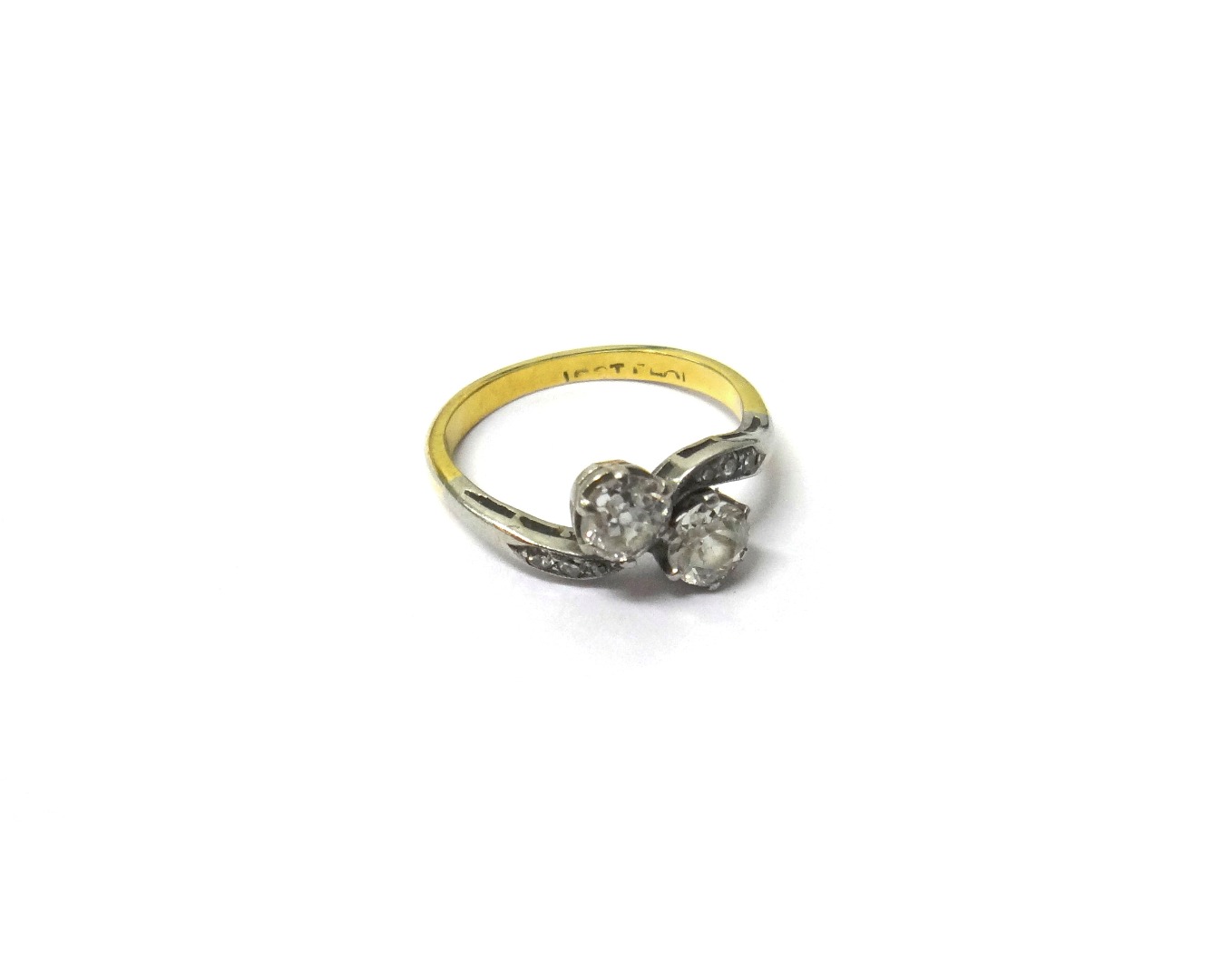 Appraisal: A gold and platinum diamond set two stone ring claw