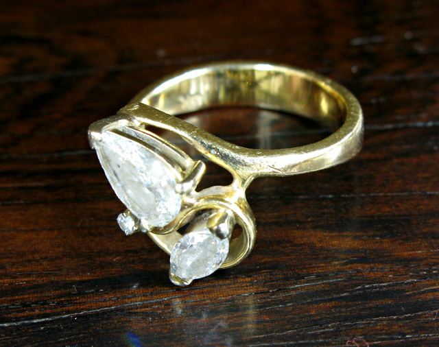 Appraisal: DIAMOND AND FOURTEEN KARAT GOLD RING set with a pear-cut