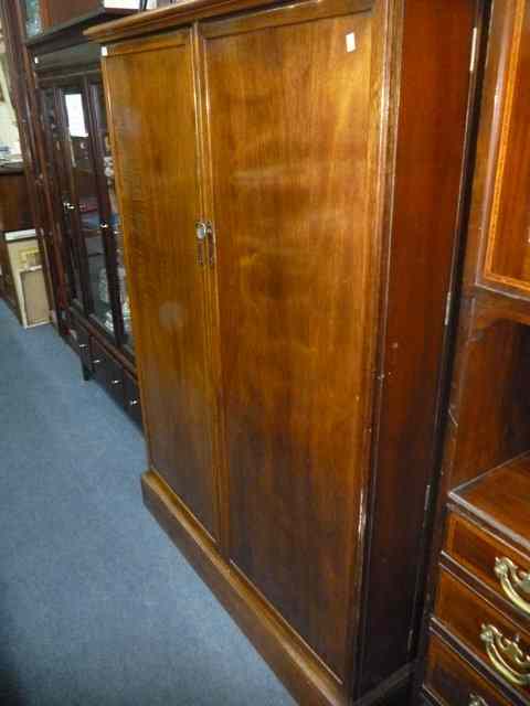 Appraisal: AN OLD MAHOGANY COMPACTOM TWO DOOR WARDROBE numbered YYN with