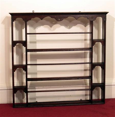 Appraisal: A Victorian oak plate rack the moulded cornice above three