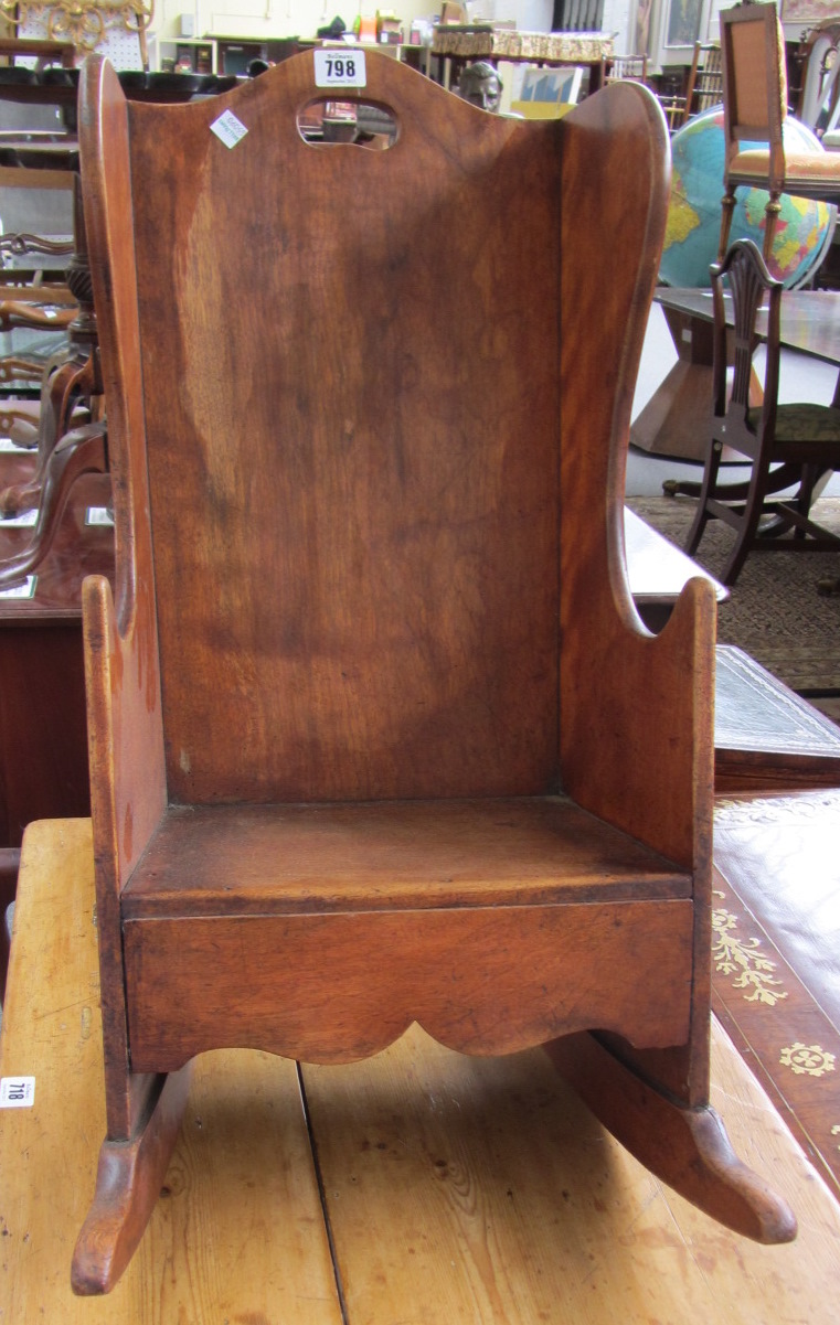 Appraisal: A th century childs fruit wood wingback rocking chair with