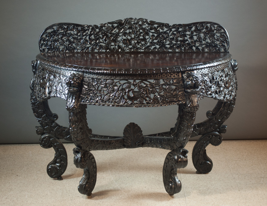 Appraisal: ANGLO-INDIAN CARVED ROSEWOOD DEMILUNE CONSOLE TABLE th century a highly