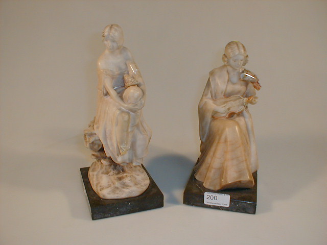 Appraisal: Two thC alabaster carved figures of young ladies one with