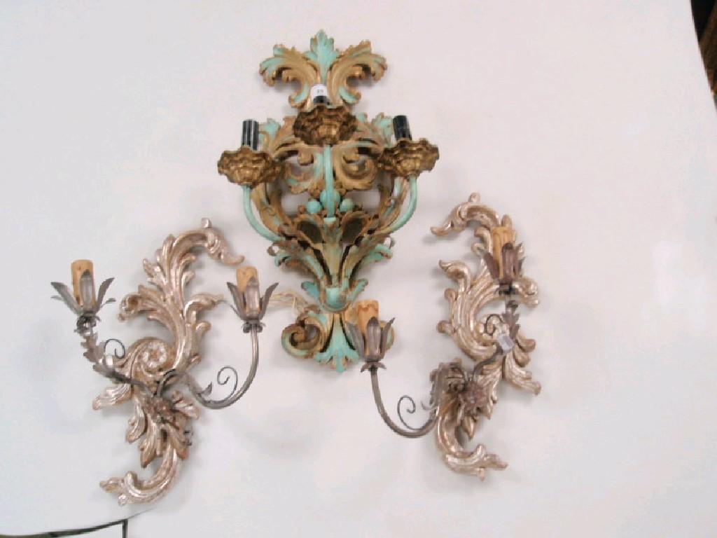 Appraisal: A garniture of three Italian carved wooden wall sconces with