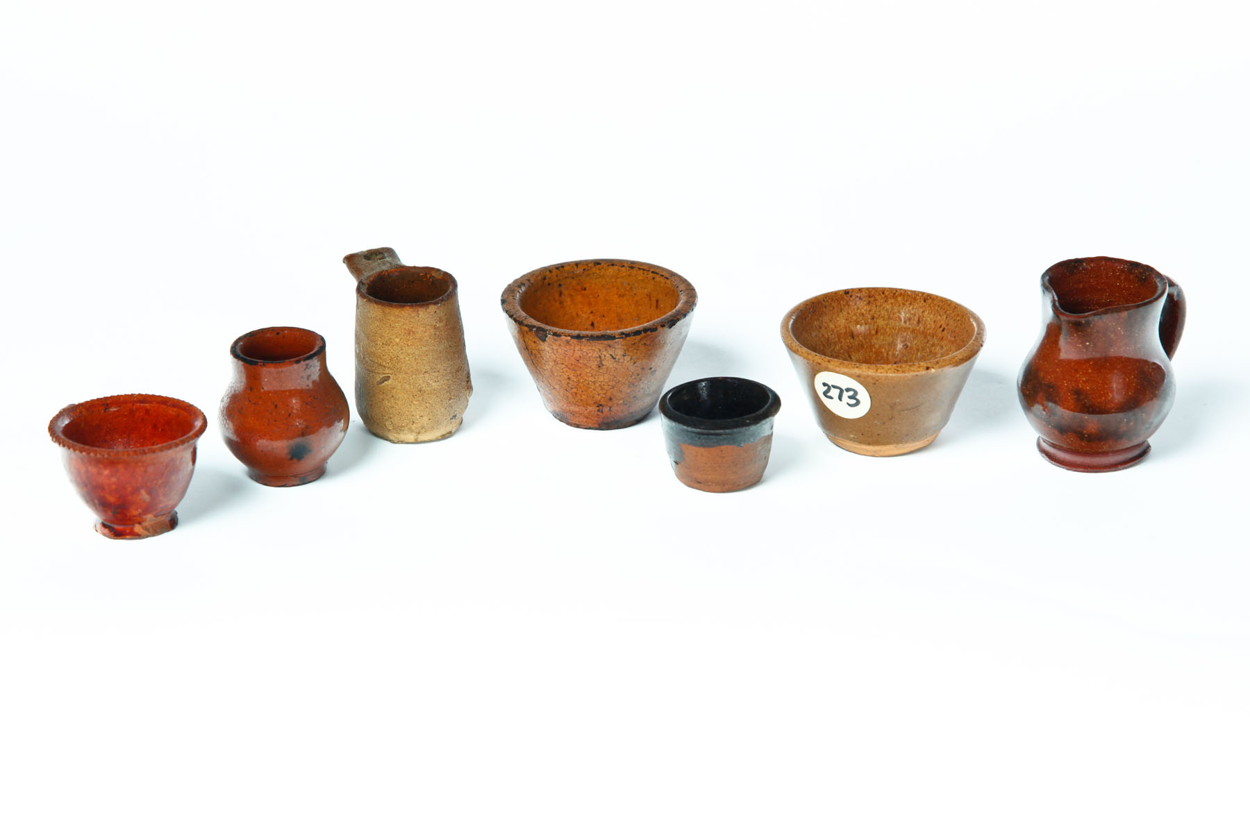 Appraisal: SEVEN MINIATURE REDWARE DISHES American mid th century Bowls cups